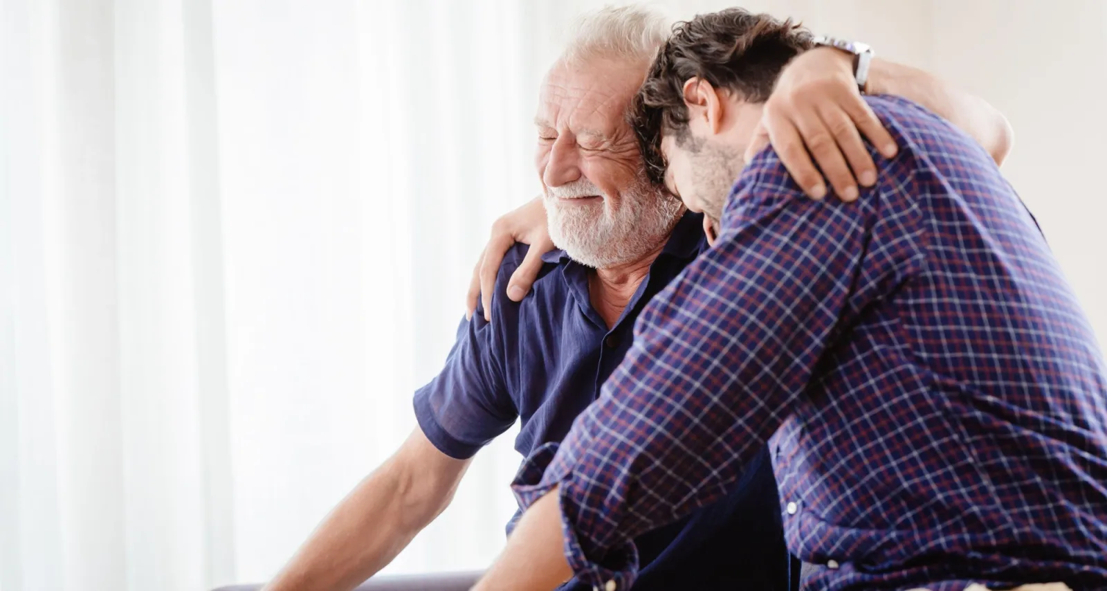 Older father and son hugging