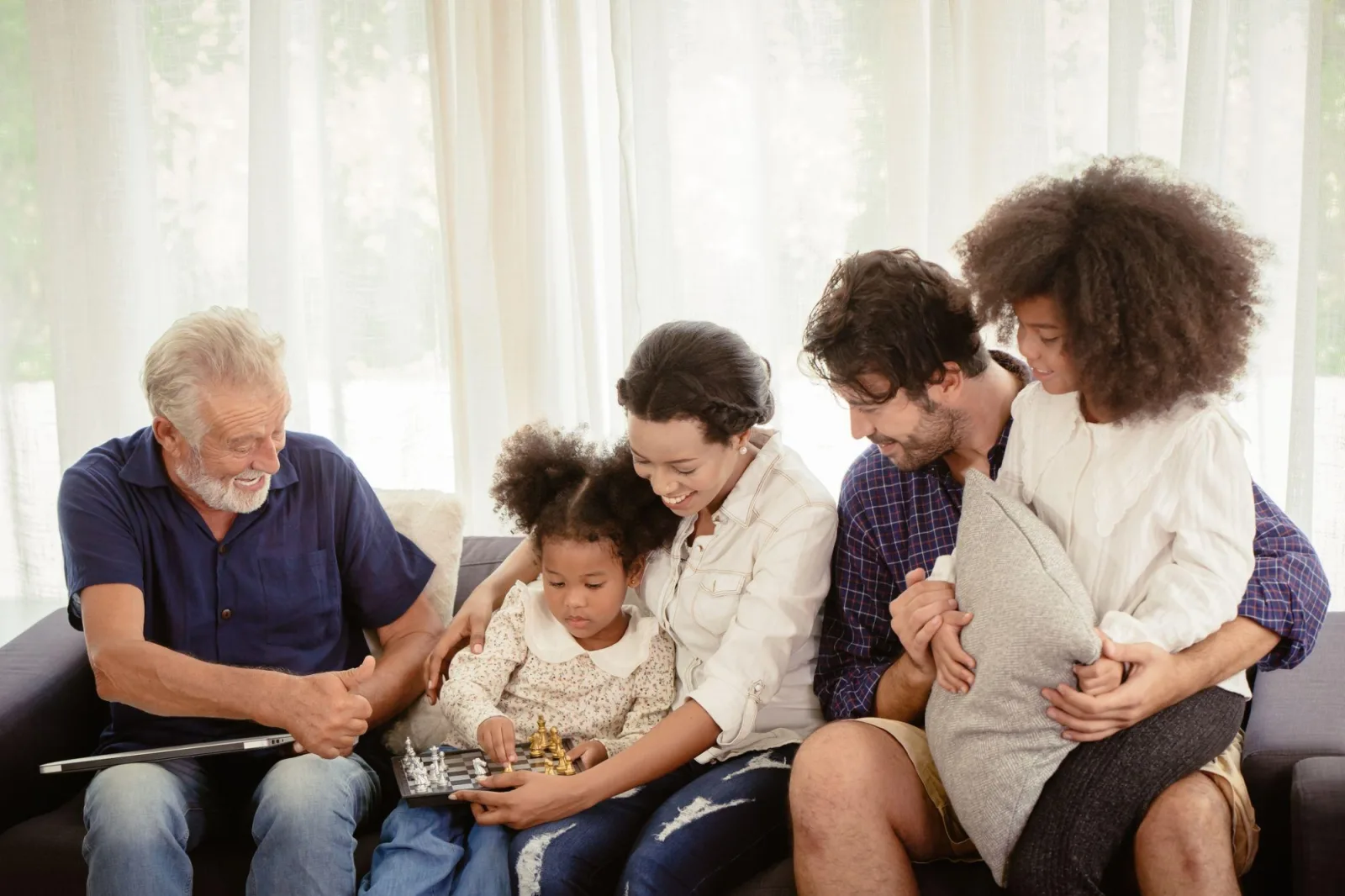 Family sitting on couch looking at photo album