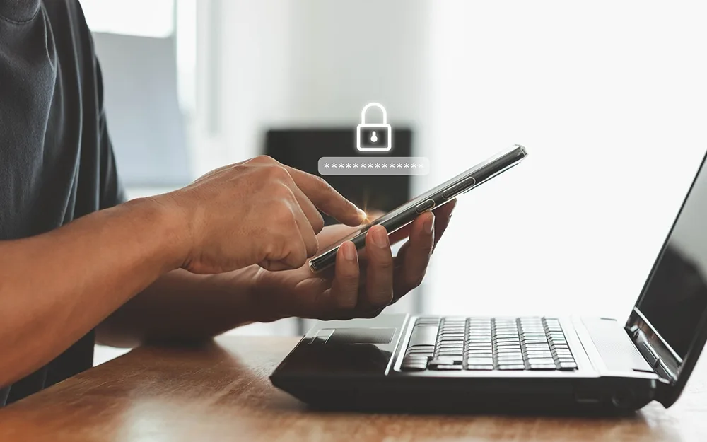 Man using phone and laptop