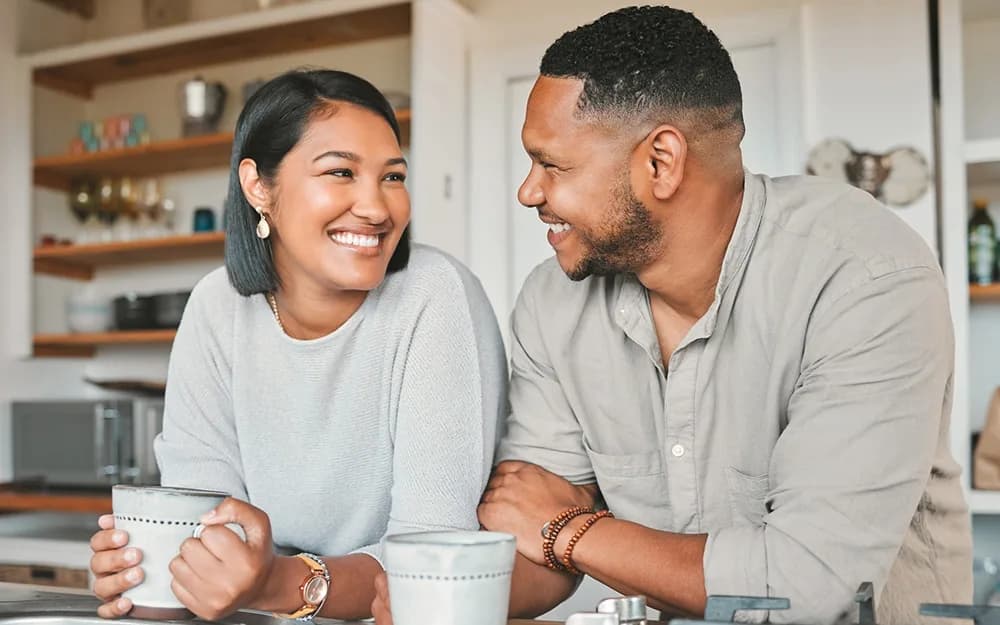Couple enjoying coffee in kitchen